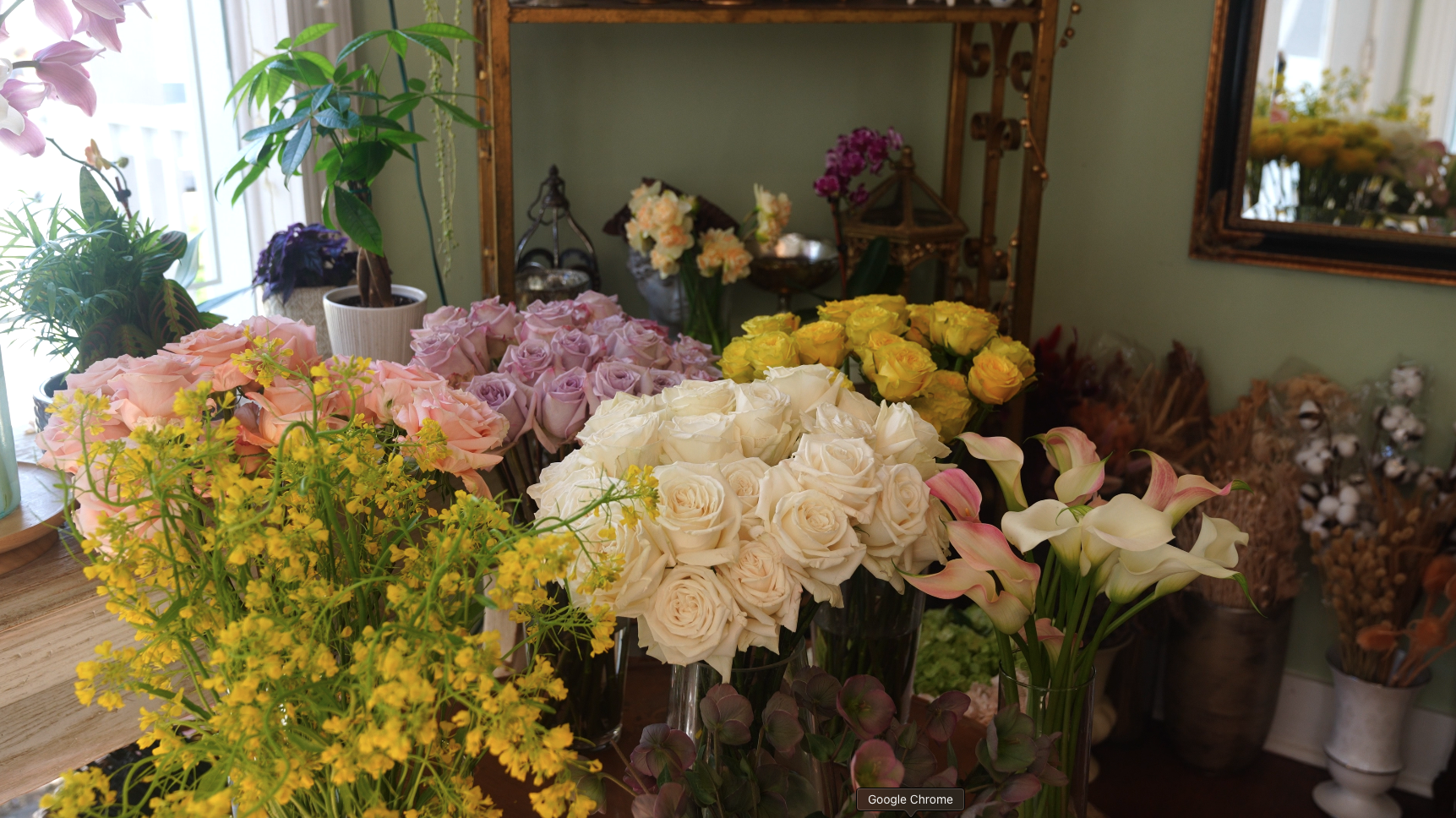 Colorful floral arrangement with roses and calla lilies at Rosaspina Floral Designs